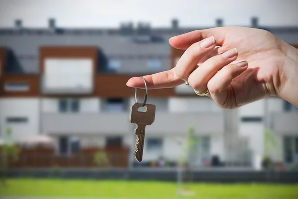 Woman's hand holding keys to new house — Stock Photo, Image