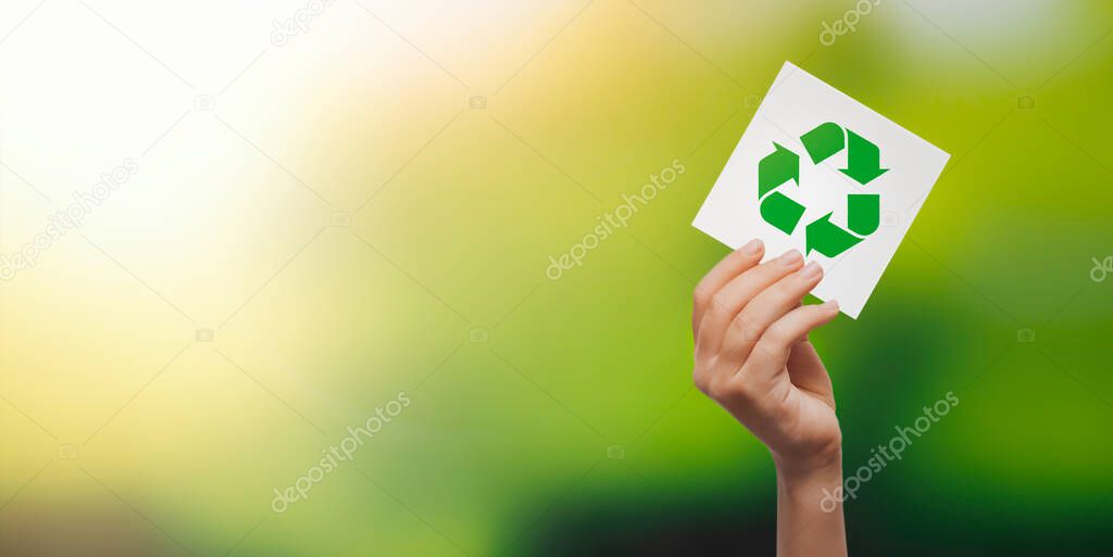Recycling symbol in hand. Ecology concept, copy space image