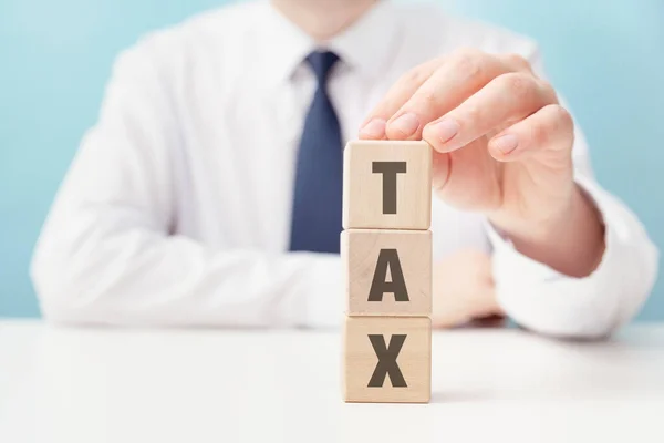 Concept Tax Businessman Builds Tower Tax Word Wooden Block — Stock Photo, Image