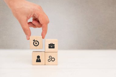 Businessman build company strategy with wooden blocks