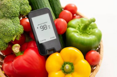 Glucometer with fresh vegetables. Healthy food, diet and nutrition