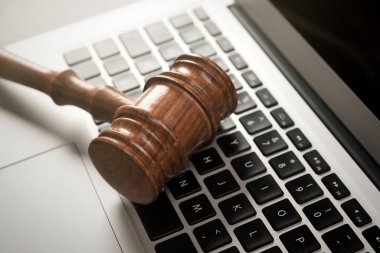Cybercrime concept with gavel on laptop. Law and justice.