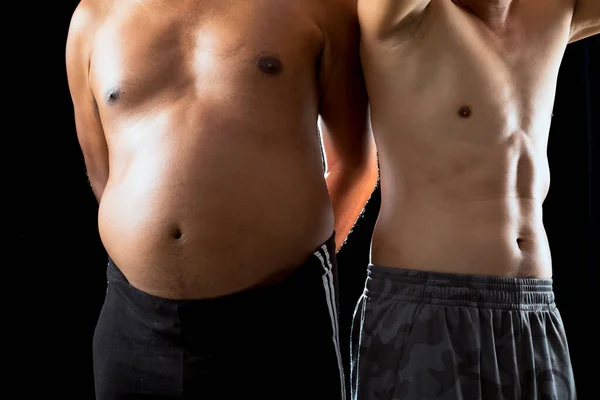 两名身穿土生土长短裤的亚洲男子站在一起 近距离对比黑人背景下的身体肌肉动力 — 图库照片