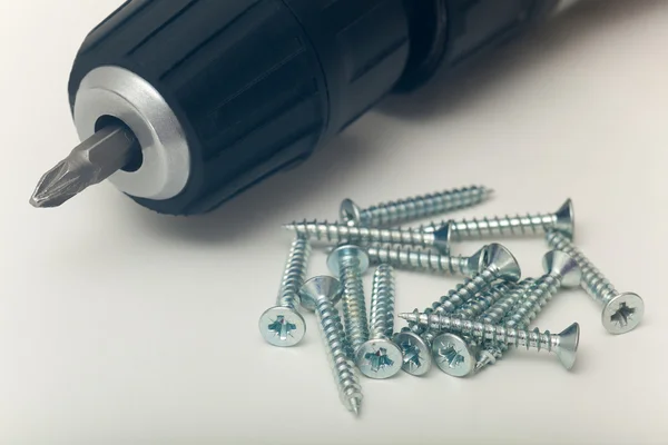 Screws and hand drill — Stock Photo, Image