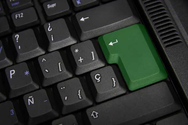 Black keyboard with green key — Stock Photo, Image