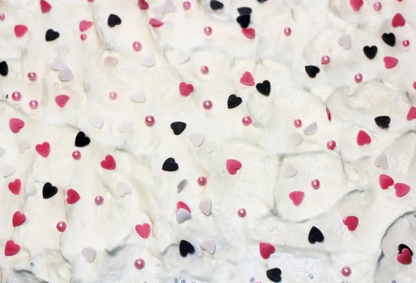 Sweet hearts on whipped cream — Stock Photo, Image