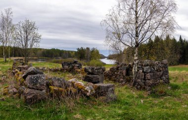 Ruins of an old Finnish stone foundation in a forest in Karelia