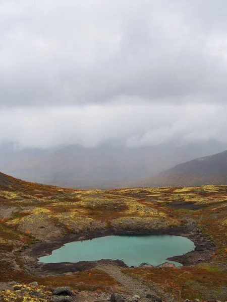 Sjön med turkost vatten i fjällen på hösten en mulen dag. vy ovanifrån — Stockfoto