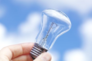 Incandescent lamp against the blue sky clipart