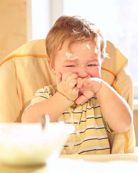 Little boy doesn't want to eat porridge. — Stock Photo, Image