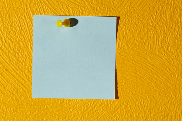 Pink sticker on the yellow wall. — Stock Photo, Image