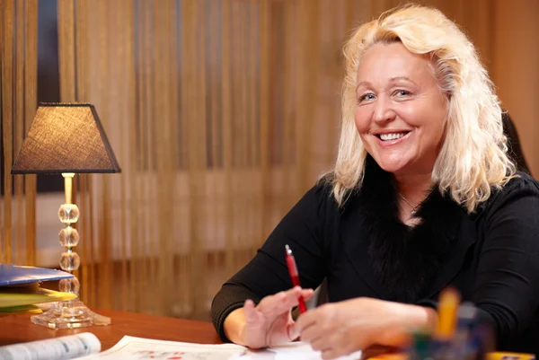 Professeur d'anglais assis à la table et souriant à la caméra . — Photo