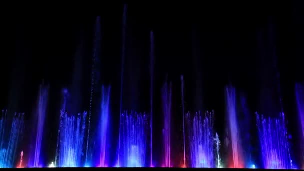 Dancing beautiful colorful fountain with reflection in the ice. — Stock Video