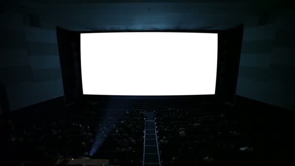 Pantalla de cine blanco con proyector de luz y público en una moderna sala de cine . — Vídeo de stock