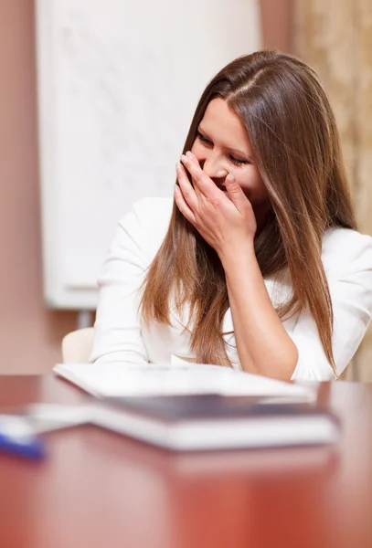 Businesswoman laughing in a meeting