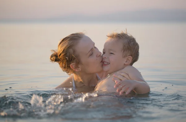 Mãe brincando no mar com seu filho — Fotografia de Stock