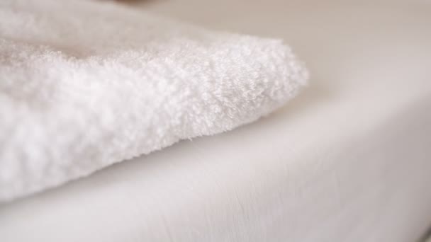 Woman placing a clean fresh white towel — Stock Video