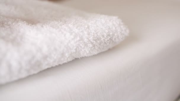 Woman placing a clean fresh white towel