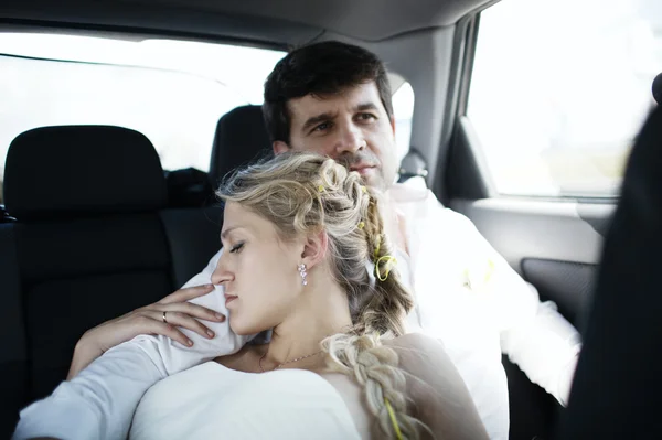 Woman sleeping on her husbands shoulder