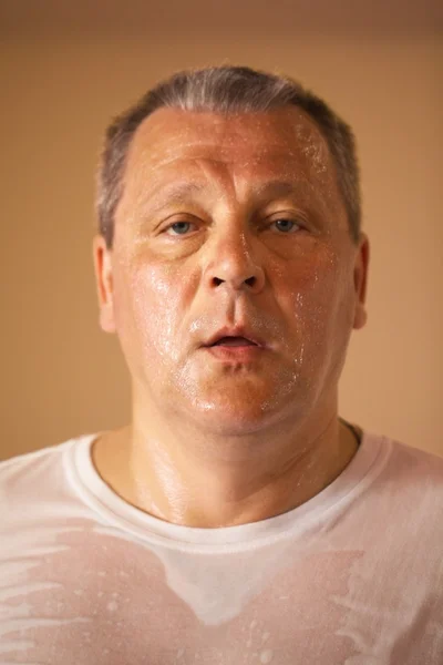 Tired looking middle-aged man after a workout — Stock Photo, Image