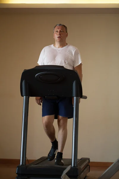 Middle-aged man working out on a treadmill — Stock Photo, Image