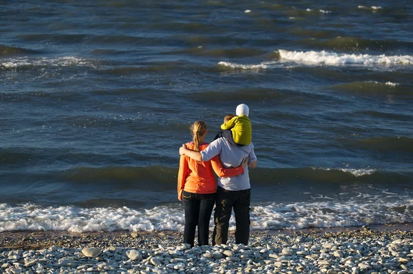 Ung familj njuter av en dag vid havet — Stockfoto