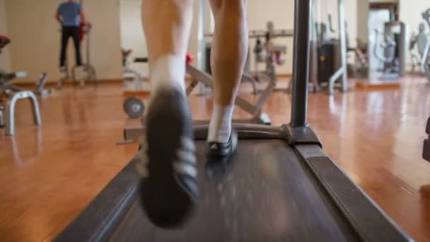 Walking feet on the treadmill — Stock Video
