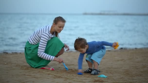 Madre e hijo jugando en la playa — Vídeo de stock