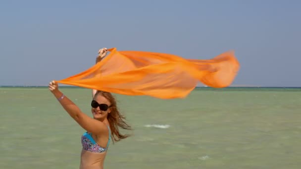 Jeune femme avec paréo sur la plage — Video