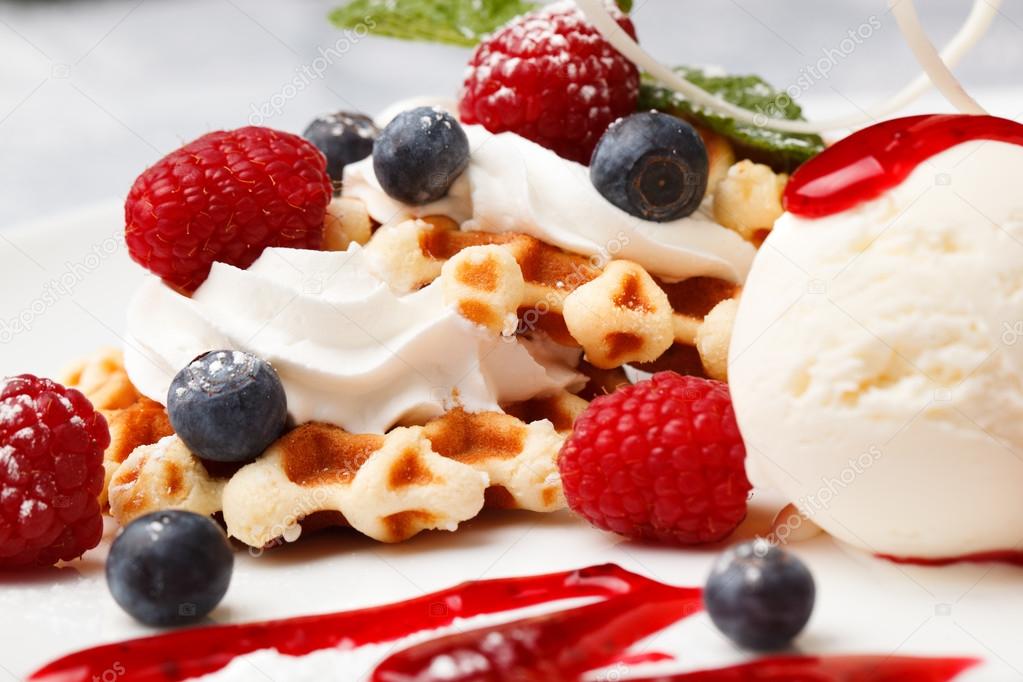 Waffle with cream, ice cream and fresh berries