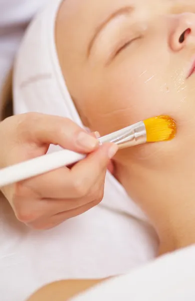 Woman being applied a facial mask — Stock Photo, Image