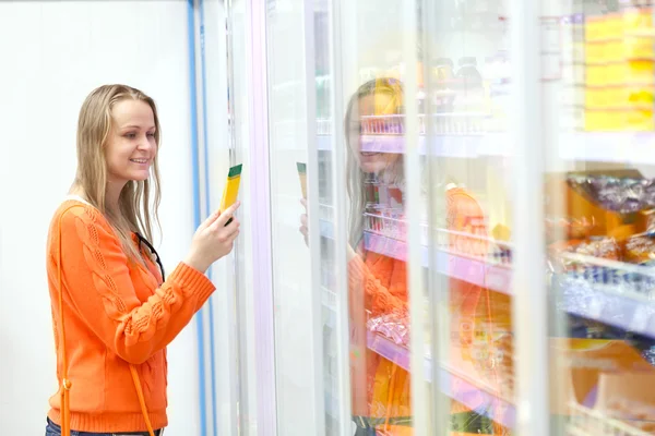 Woman taking product from the showcase Stock Picture