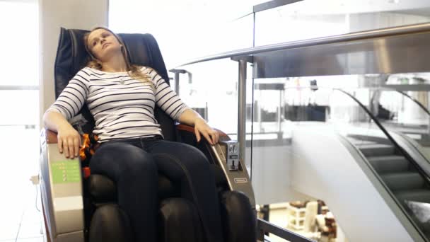 Woman having a rest in massage chair — Stock Video