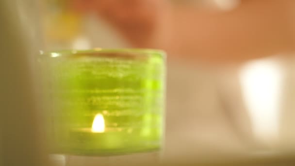 Putting joelle ciocco cosmetic near burning candle — Stock Video