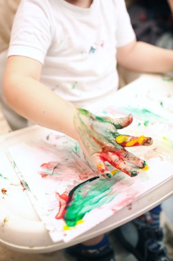 Boy painting with finger-paints clipart