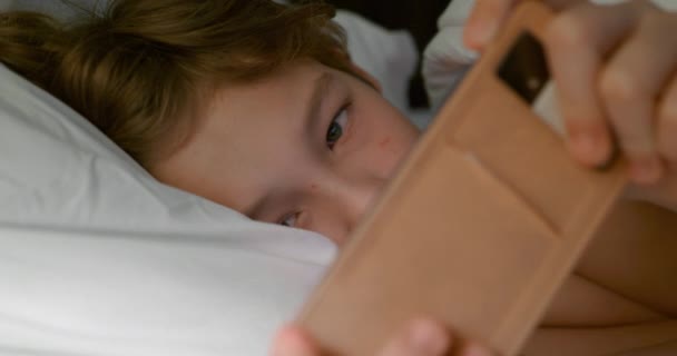 Teenage Boy Lying Bed Using Smartphone Surf Net Play Games — Stock videók