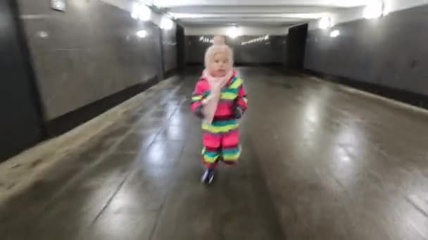 Little Girl Winter Overclothes Running Underground Walkway Child Looking Back — Stockvideo
