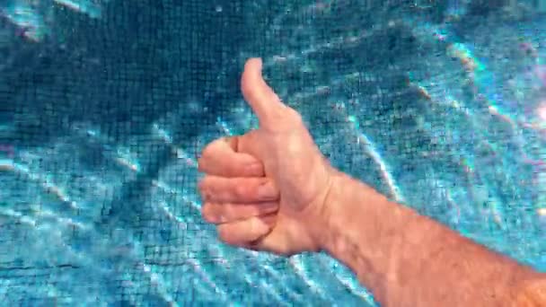 Man Showing Thumbs Underwater Swimming Pool Sun Sparkling Blue Tile — ストック動画