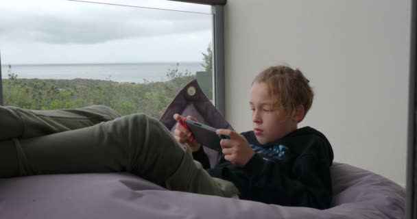 Teenage Boy Relaxing Home Video Games Child Lying Beanbag Bag — Stockvideo