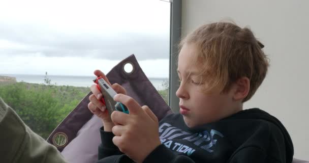 Adolescent Boy Spending Free Time Home Playing Video Games Handheld — Video Stock
