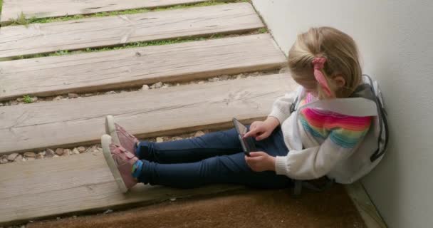 Kid Using Smartphone While Waiting House Front Door Little Girl — Vídeo de Stock