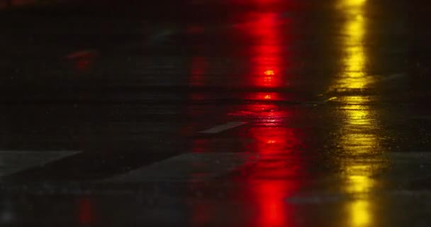 Pedestrians Crossing Road Rain Night Cars Passing Colorful Lights Reflecting — стоковое видео