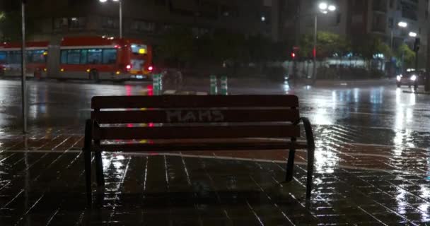 Single Empty Wooden Bench Street Pouring Rain Night City View — Stockvideo