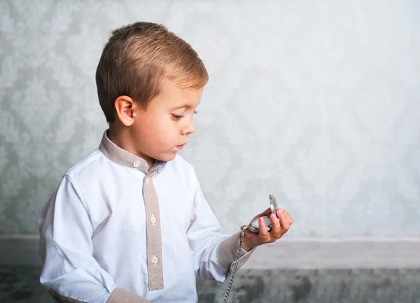 Boy with the old clock — Stock Photo, Image
