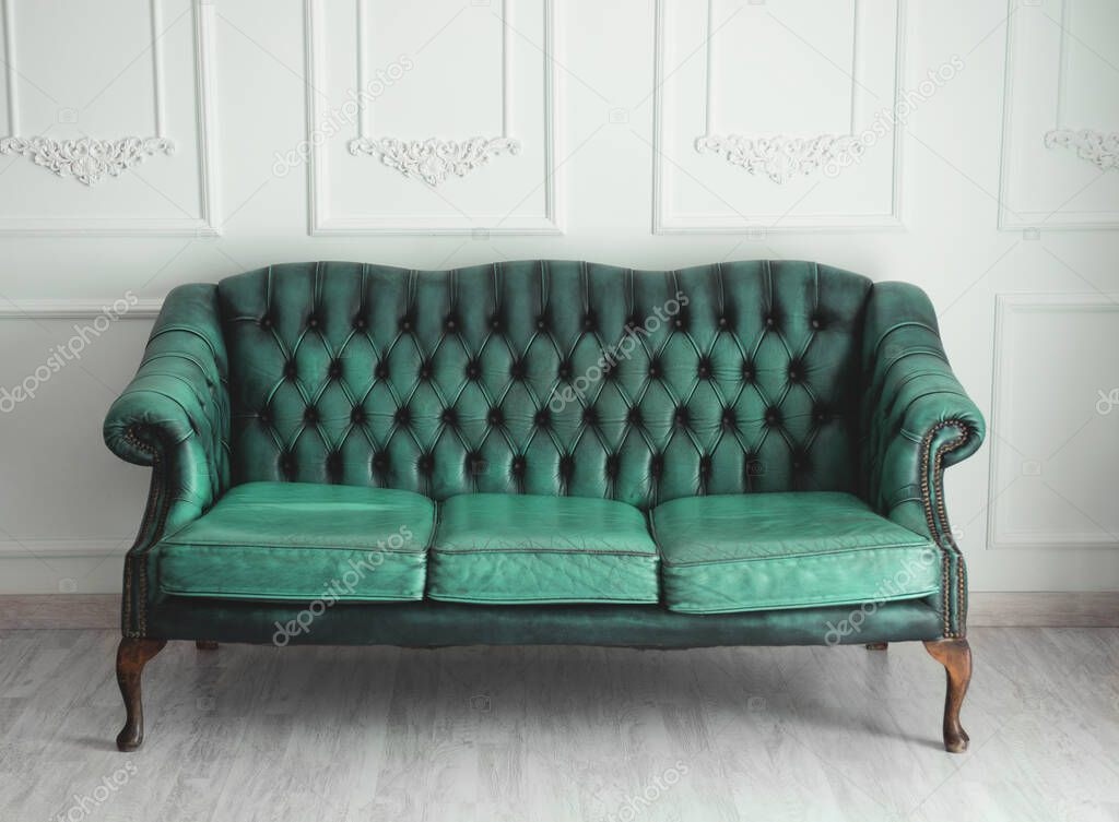 Beautiful antique blue sofa on a light background.