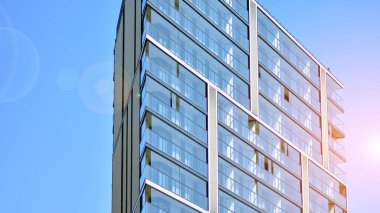 Modern apartman binası. Modern şehir mimarisi ve bina cephesinin ayrıntıları. Güneş ışığı.