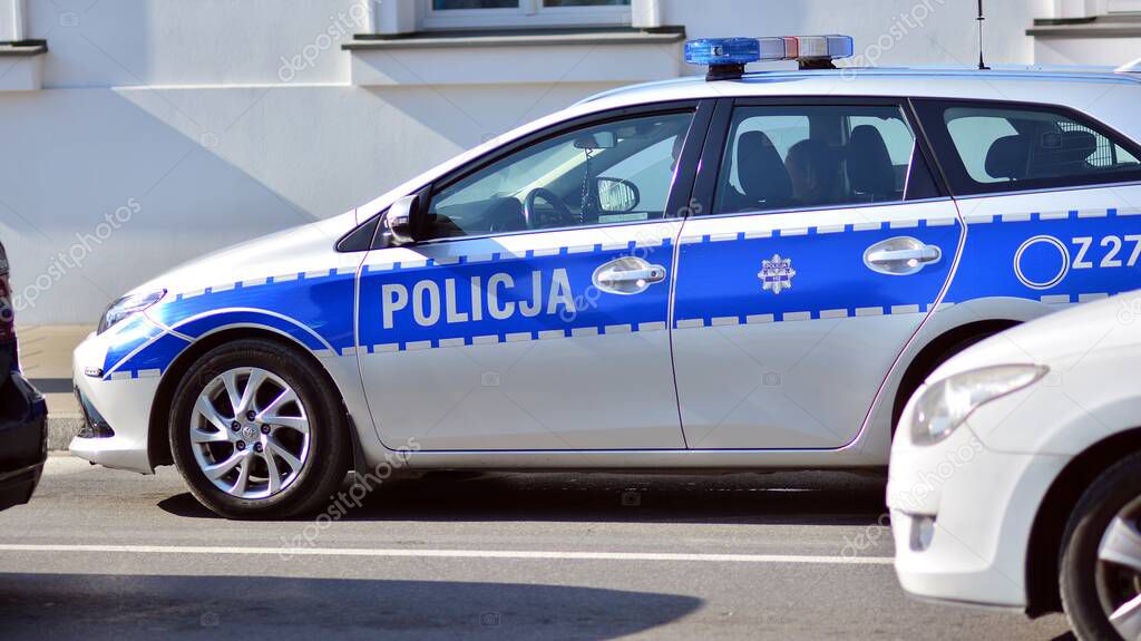Warsaw, Poland. 4 Oktober 2021. Policeman on a street in police car. Police sign.