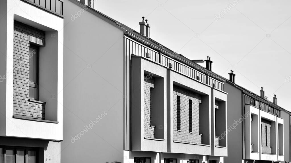 Modern single family terraced homes. Newly built homes in a residential estate. Black and white.