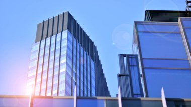 Modern şehrin iş bölgesindeki bina parçaları. Şehir merkezindeki yüksek katlı ofis binası. Tipik beton, cam ve çelikten modern mimari.