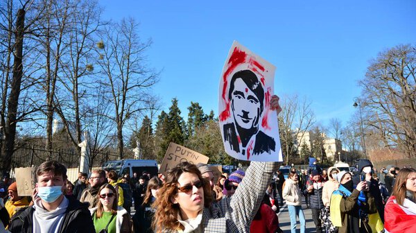 Warsaw, Poland. 24 February 2022. Anti-war protest outside Russian embassy in Warsaw. Demonstrators call for peace and condemn Putin. 
